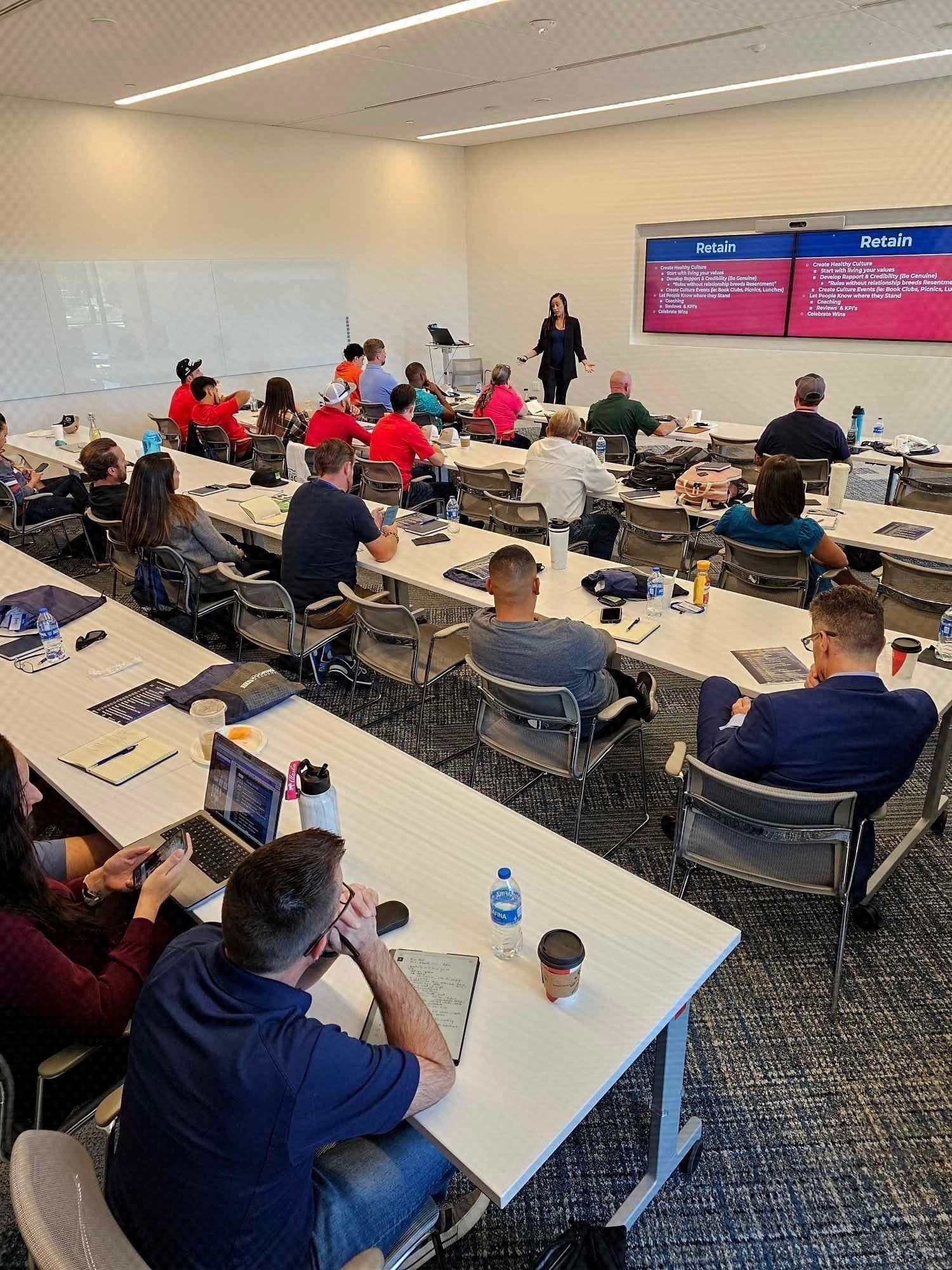 A room of roofing company owners working through a session at a Roofing Academy workshop