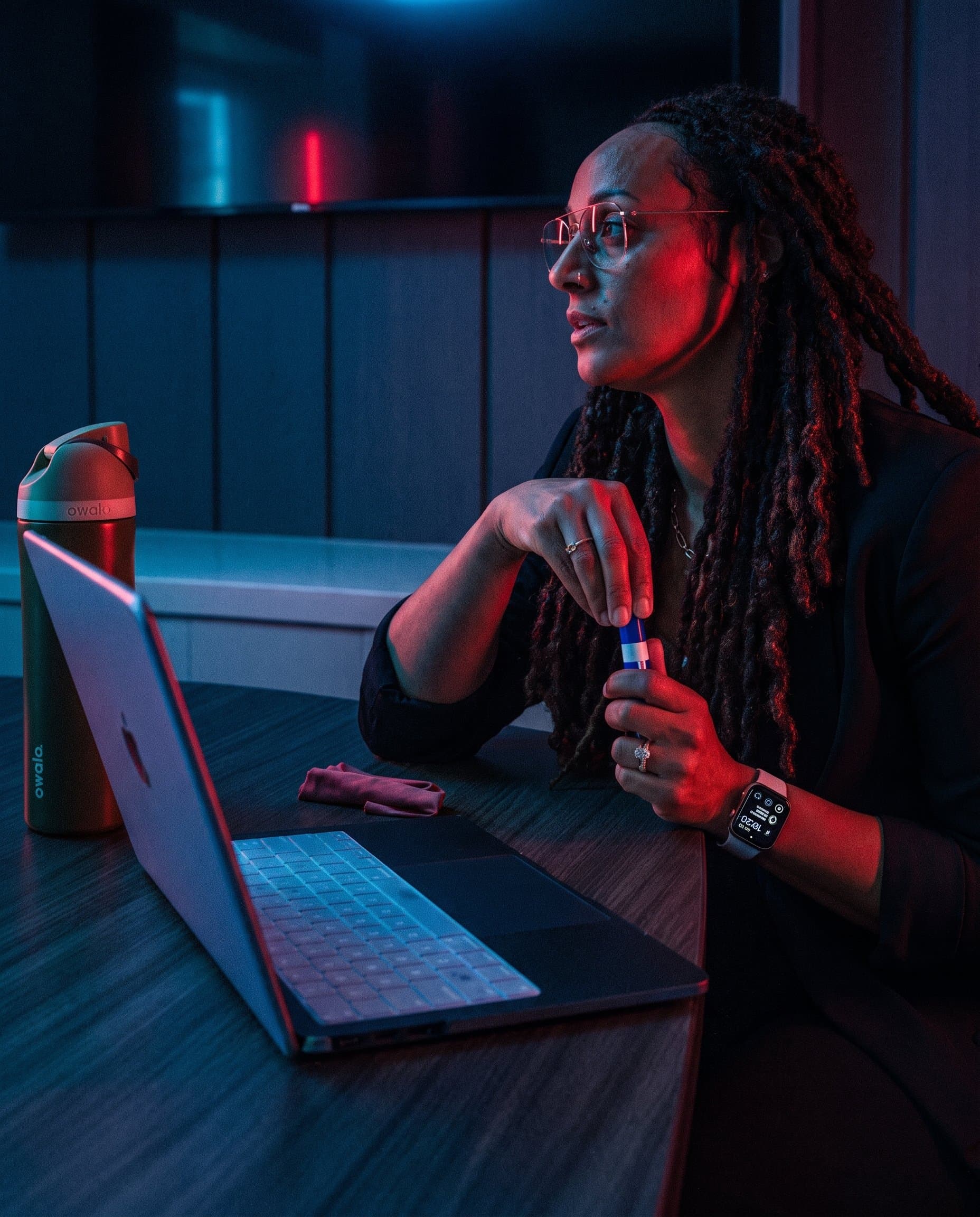 A Roofing Academy coach at her laptop during a remote working session, a CRM workflow chart on the screen behind her.